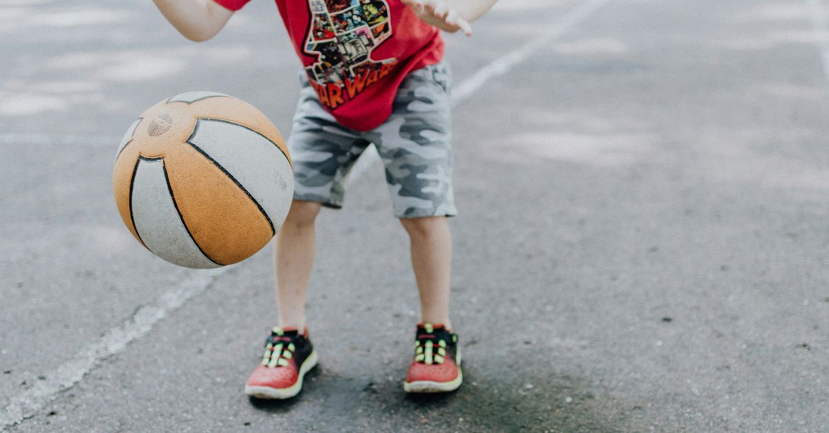 Boy-outdoors-bouncing-a-basketball.jpg